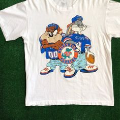 Ncaa 1993 Florida Gators Looney Tunes T Shirt, University Of Florida Shirt, Ncaa Vintage Shirt, Basketball Vintage Shirt, Graphic Tee Shirt Reprinted Shirt Made By Gildan Brand 5.3-Ounce, 100% Cotton (99/1 Cotton/Poly (Ash) & 90/10 Cotton/Poly (Sport Grey) Heavyweight Classic Unisex Tee Taped Neck And Shoulders; Tearaway Label Decoration Type: Digital Print Club Shirts School, Vintage Hoodies Aesthetic, Friday Fits, Graphic Tess, School Spirit Shirts Designs, Basketball Vintage, Florida Shirt, Florida Gator, Hoodies Aesthetic