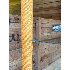 a tall wooden pole sitting next to a glass shelf