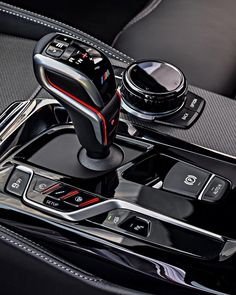 the interior of a car with an automatic gear box and steering wheel control knobs