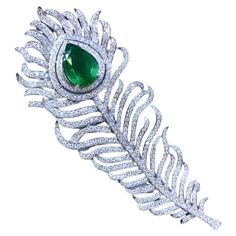 A brooch is a lovely and classic adornment that is always well - received. And when it comes to brooches , a Feather diamonds brooch is truly a work of art . Its delicate and intricate details , combined with the dazzling , make it a stunning addition to any ensemble. It's a gift that will be cherished and admired for its timeless beauty. Magnificent brooch come in 18k gold with a Natural Zambian Emerald , in perfect pear cut, extra fine quality, of 5,00 carat, and 490 pieces of Natural Diamonds of 4,80 carats, in round brilliant cut, F-G color VS clarity, very sparkly. Handcrafted by artisan goldsmith. Compiette with certificate. Wholesale Price. Our Promise: Top Quality Customer Service. High Quality Product. Free Worldwide Express Shipping , Taxes Free. Luxury Green Pendant Brooches, Luxury Turquoise Elegant Brooches, Luxury Green Art Deco Brooches, Luxury Antique Green Brooch, Luxury Green Pendant-shaped Brooches, Art Deco Brooch, Luxe Jewelry, Zambian Emerald, Diamond Brooch