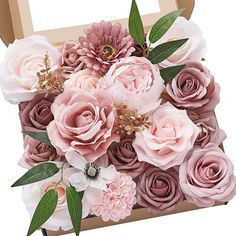 a cardboard box filled with pink flowers and greenery