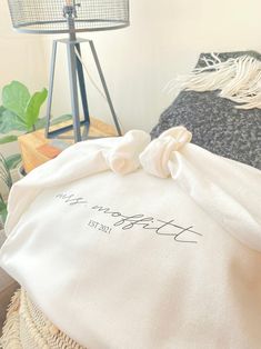 a white bag sitting on top of a table next to a lamp