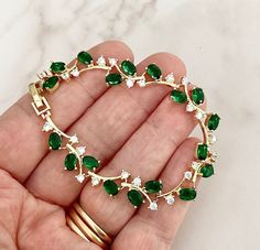 This emerald coloured bracelet has been created with AAA grade cubic zirconia crystals , this piece is fully adjustable so will fit most wrists.     An Ideal gift for most occasions but would especially suit the Bride, Bridesmaids, Mother of the Bride or even wedding guests !  All my bridal accessories are made to the very highest standard using the finest quality materials whilst paying care and attention to detail. Materials  . Sparkling finest AAA grade cubic zirconia crystals  . Emerald colo Emerald Green Bracelet, Emerald Green Wedding Theme, Emerald Green Jewelry, Green Quince, Green Jewellery, Bracelet Emerald, Emerald Green Weddings, Green Accessories, Emerald Bracelet