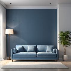 a blue couch sitting in front of a window next to a lamp and potted plant