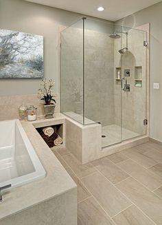 a bathroom with a walk in shower next to a white sink and bathtub under a painting on the wall