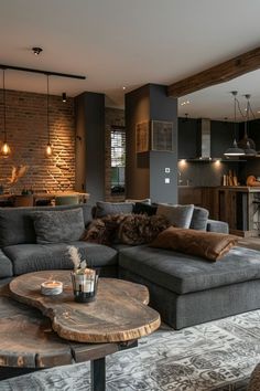 a living room filled with furniture next to a brick wall