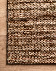 a close up view of a woven mat on a wooden surface, with the top section showing