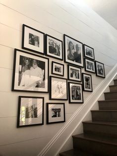 a staircase with many framed photos on the wall