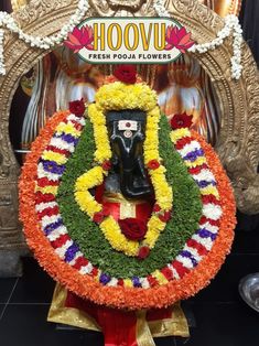 the idol is decorated with flowers and leaves