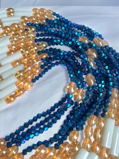 Double Strand Waist Bead "Koffikro" features two strands adorned with rich, deep blue glass seed beads. Dive into the enchanting allure of this accessory, designed to add a touch of sophistication and mystery to your style. 🌌 Blue : Immerse yourself in the deep and luxurious shades of blue that adorn each strand of this waist bead. The profound color symbolizes tranquility and depth, making it a perfect choice for expressing your inner calm and timeless elegance. 🌟 Double Strand: The double strand design adds a layer of opulence and texture, creating a visually stunning and intricate accessory. The strands cascade gracefully, allowing you to make a bold and refined statement with every movement. 🔵 Versatile Expression: Whether worn under clothing for a discreet touch or as a visible sta Handmade Blue Double Strand Beaded Bracelets, Multi-strand Blue Spacer Beads, Blue Multi-strand Spacer Beads, Blue Beaded Chain Bracelets For Party, Blue Beaded Necklaces With Oval Beads, Multi-strand Polished Czech Glass Beads, Blue Oval Beaded Necklaces, Polished Czech Glass Multi-strand Beads, Spiritual Blue Beaded Chain