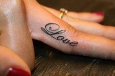 two hands with the word love tattooed on them