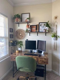 a desk with two computer monitors and a green chair in front of the monitor screen