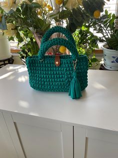 Handbag; Crochet by hand using T-shirt yarn made of polyester/cotton blend; Single clasp; inner pocket; and single tassel. Crochet By Hand, Handbag Crochet, Crochet Handbag, Green Crochet, T Shirt Yarn, Crochet Handbags, Gold Accents, Purses And Handbags, Tassels