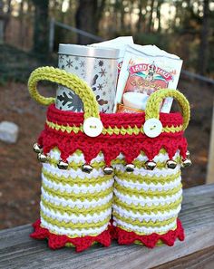 two crocheted baskets are sitting on a wooden bench with coffee cups in them