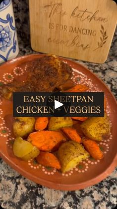 a plate with carrots, potatoes and meat on it next to a wooden cutting board