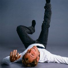 a man laying on the ground with his legs spread out in front of him, and an advertisement about men's health