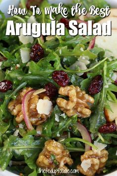 arugula salad with walnuts and cranberries in a white bowl