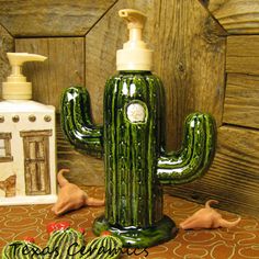 a green cactus shaped soap dispenser sitting on top of a table