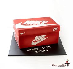 a red nike box cake with the words happy 19th kynan printed on it's side