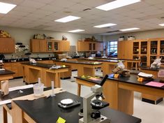 a lab with lots of desks and shelves filled with laboratory supplies on top of them