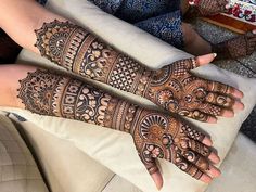 two hands with henna designs on them