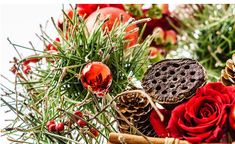 a basket filled with lots of different types of christmas decorations and flowers on top of a table