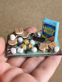 there is a miniature tray with marshmallows and cookies on it