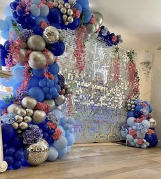 balloons and streamers decorate the entrance to a birthday party