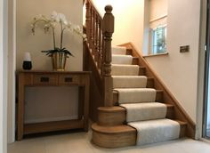 there is a vase with flowers on top of the stair case next to the stairs