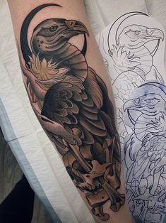 an eagle and skull tattoo on the left arm, with another bird in the background