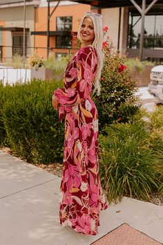 - Go wine tasting in this fabulous maxi! Its flowy silhouette and feminine floral print give it romantic energy, making it a perfect option for taking in scenic vineyard views with your sweetheart. Wrap yourself in chic style with this gorgeous dress! - Airy chiffon material with an abstract floral print featuring pink, latte, cream, and different orange hues - A v-cut neckline - A built-in bodice and skirt lining - Long, sheer sleeves with elastic cuffs - A wrap style front that loops through a Romantic Energy, Elegant V-neck Maxi Dress With Vibrant Print, Flowy V-neck Maxi Dress With Vibrant Print, Pink Latte, Bohemian Maxi Dress With Vibrant Print And V-neck, Vibrant Printed V-neck Maxi Dress, Skirt Lining, Wrap Maxi Dress, Bohemian V-neck Maxi Dress With Abstract Print