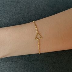 ✦Please contact me if you need MORE QUANTITY of this item. ✦ DETAILS ABOUT THIS Bracelet: ▸A very delicate and beautiful gold polished chain and triangle with hexagon charm bracelet.  ▸Size: Chain 6 + 1.5 inches extension.    Triangle :11 mm Weight: 1. gm ▸Materials: Brass plated with gold ✧Gold plated jewellery is an affordable hypoallergenic alternative to real gold and can be worn by people with sensitive skin ✦ PACKAGING: ▸Your order is packed securely in a beautiful box ready to gift out if required. Please inform me if you require separate boxes for orders of more than one item. ✦ SHIPPING: Orders are processed and sent out between 1 to 3 days.  ▸ I offer a shipping upgrade if required. ▸Thank you for visiting my shop.  Hope you find something you love. You can contact me on nineplan Dainty Brass Bracelet For Gift, Dainty Brass Bracelet As Gift, Dainty Brass Bracelet For Gifts, Minimalist Gold Plated Charm Bracelet As Gift, Gold Brass Bracelet With Adjustable Chain As Gift, Adjustable Chain Brass Gold Bracelet Gift, Gold Triangle Metal Jewelry, Minimalist Gold Plated Chain Bracelet Gift, Minimalist Gold Charm Bracelet For Friendship