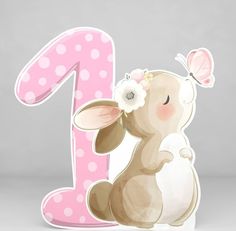 a pink and white number one with a bunny holding a flower in front of it