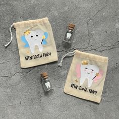 two small bags with tooth fairy designs on them, one is empty and the other has a bottle