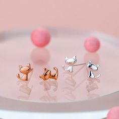 These tiny cat silhouette stud earrings from The Silver Luna make it easy and effortless to bring a feline friend by your side all day long. Crafted from high polish sterling silver, the simple yet delightful cat shape design adds a subtle, sweet touch to any outfit. Whether you're an avid cat lover, or know someone who is, these cat stud earrings offer a fun and fashionable way to pay homage to our purrfect companions, without all the hair and fur. Perfect for everyday wear, they're ideal for c Cat Stud Earrings, Tiny Cats, Cat Earrings Studs, Cat Silhouette, Animal Earrings, Silver Coat, Earring Crafts, Moonstone Jewelry, Fine Jewellery Earrings