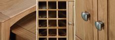 a wooden cabinet with glass doors and drawers