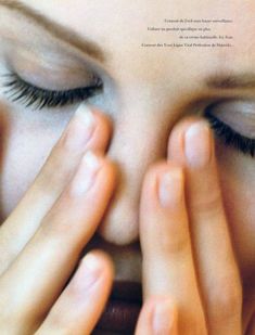 a woman covering her eyes with her hands