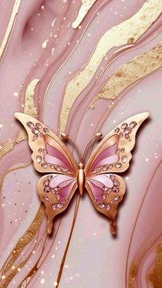 a pink and gold butterfly sitting on top of a marble surface with glittery swirls