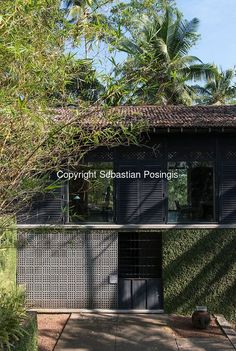 the entrance to a building that is surrounded by trees