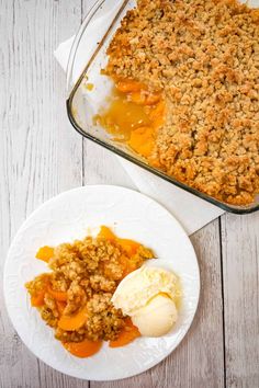 two plates with food on them next to a casserole dish and ice cream