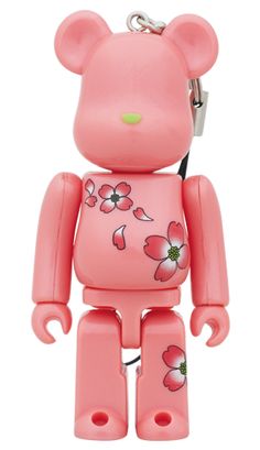 a pink bear with flowers on it's chest and head is attached to a key chain