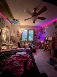 a bedroom with purple lights and pictures on the wall, carpeted floor, and ceiling fan