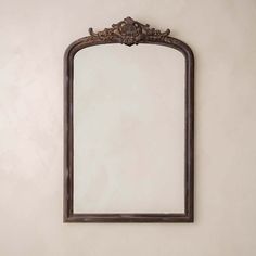 an ornate mirror hanging on the wall