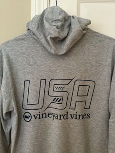 This is a Vineyard Vines Men's hoodie long sleeve shirt. On the front, it says "USA" and "Vineyard Vines" in navy blue lettering. On the back, it says "USA" and "Vineyard Vines" in bigger and navy blue lettering.   On the right sleeve, it has an American Flag. The color is Gray Heather. The size is Small. This is brand new with original tags. Never been worn.  I do combine shipping so please let me know what you would like to combine. Comes from a smoke free home!  No returns. If you have any qu Vine Yard Vines Outfits, Vineyard Vines Whale Sticker, Vineyard Vines Shirts Women, Vinyard Vine Shirt, Vineyard Vines Long Sleeve, Vineyard Vines, Long Sleeve Hoodie, American Flag, Hoodies Men