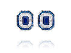 These Sterling Silver Art Deco Stud Earrings feature a beautiful blue spinel center stone surrounded by sparkling cubic zirconia. The intricate design is reminiscent of a vintage estate piece, adding a touch of sophistication and elegance to any outfit. These earrings can be paired with the matching ring and pendant for a complete and coordinated look. Blue Diamond-accented Evening Earrings, Elegant Blue Diamond Earrings With Pave Setting, Elegant Blue Hand Set Earrings, Blue Diamond Earrings With Sparkling Stones, Exquisite Blue Earrings With Diamond Accents, Blue Cubic Zirconia Diamond Earrings For Formal Events, Dazzling Blue Diamond Earrings, Formal Blue Pave Set Earrings, Blue Pave Set Earrings For Formal Occasions