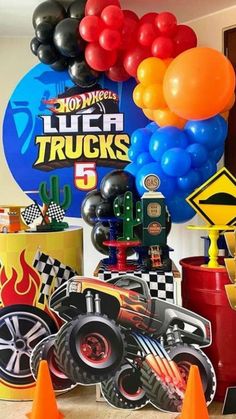 a birthday party with cars and balloons