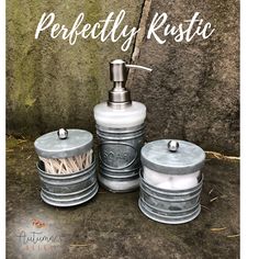 three tin canisters with soap dispenser and toothbrush in them