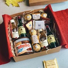 a box filled with lots of different types of wine and liquor bottles next to a gold medal