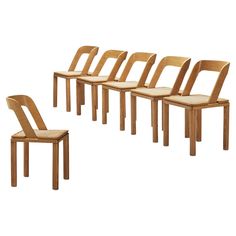 six wooden chairs sitting next to each other