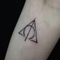 a harry potter symbol tattoo on the left forearm and right arm, with a black outline